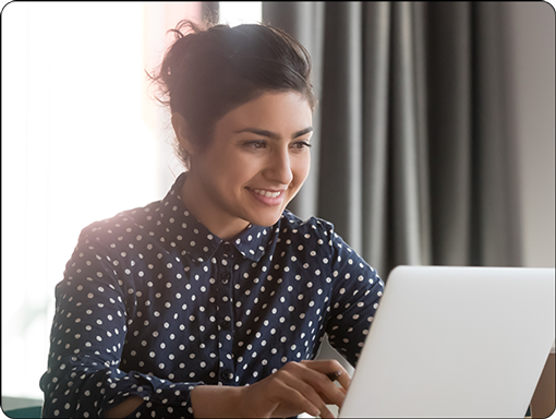 Woman smiling using laptop