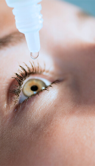 Applying eye drops to eye at Eye Consultants